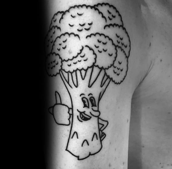 Cartoon-style broccoli tattoo on the arm, featuring bold black outlines and a playful expression giving a thumbs-up for a fun design.