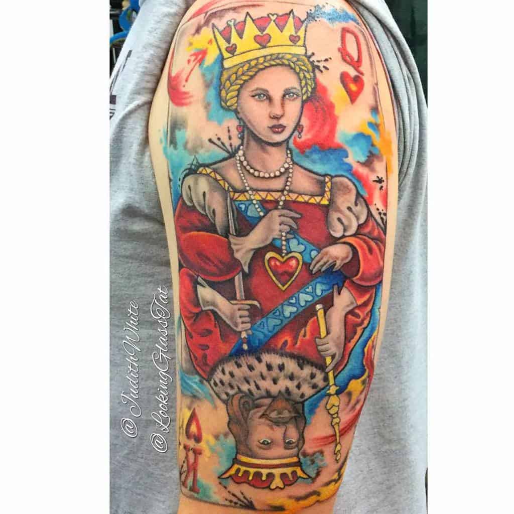 Colorful tattoo of queen and king of hearts on an arm