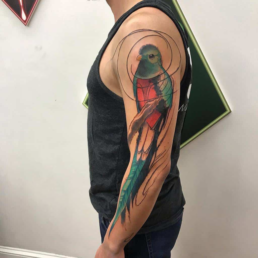 Man with a vibrant quetzal tattoo on his arm