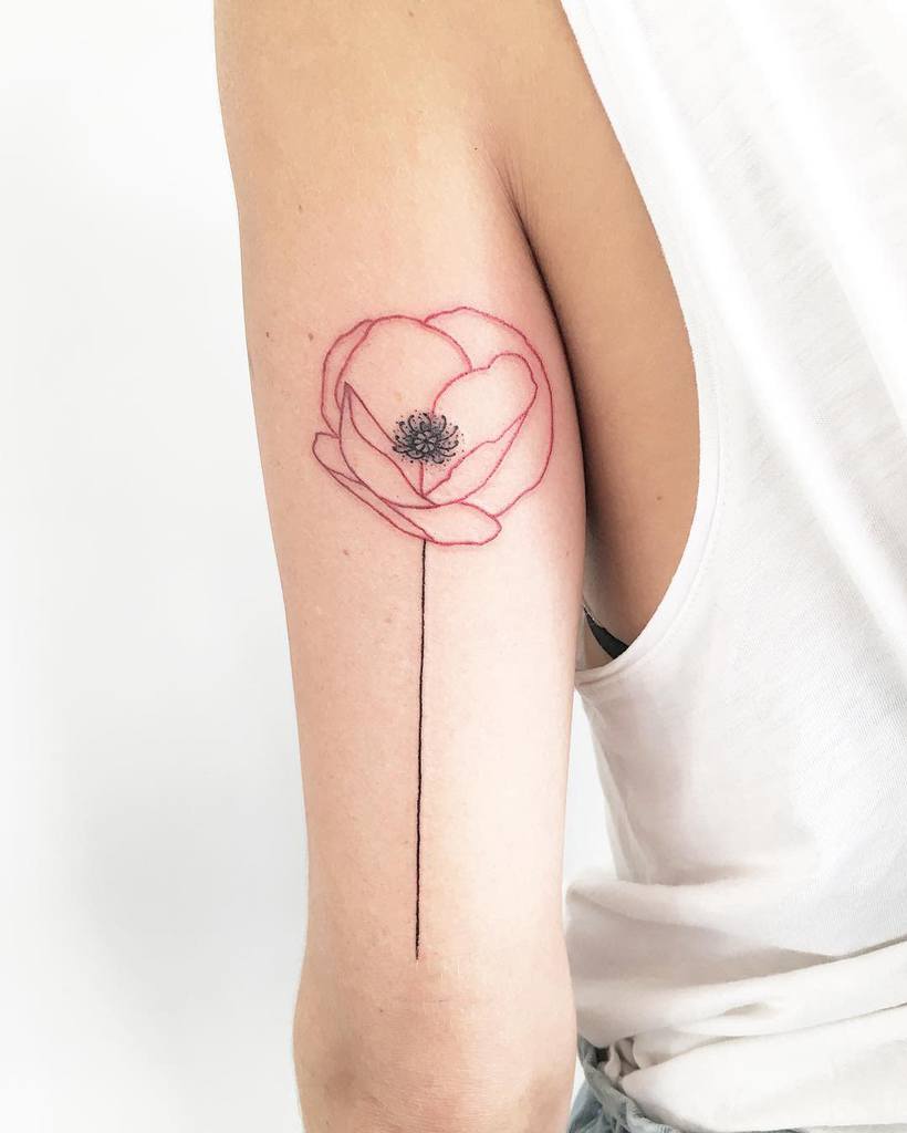 Simple line-art flower tattoo on an upper arm