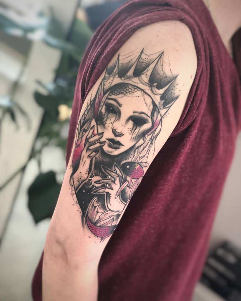 Stylized arm tattoo of a siren with a crown, dramatic shading, and flowing details, evoking a mystical aura