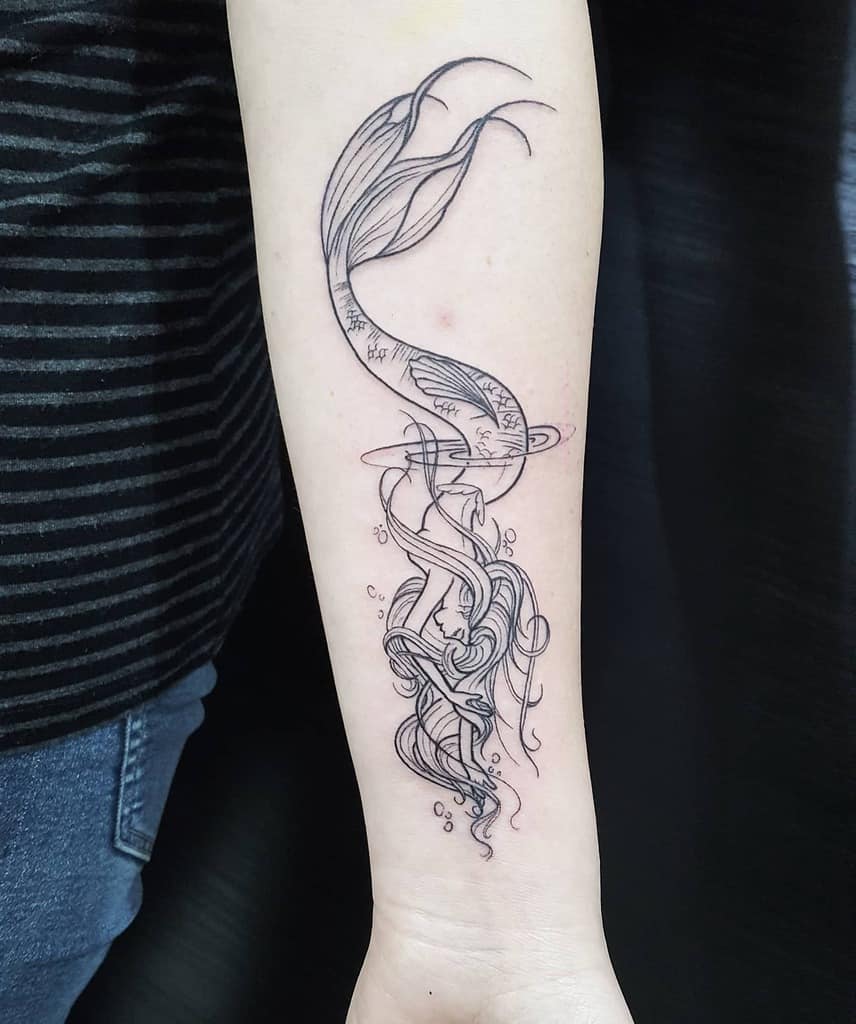 Sketch-style tattoo of a siren with flowing hair and tail on a forearm