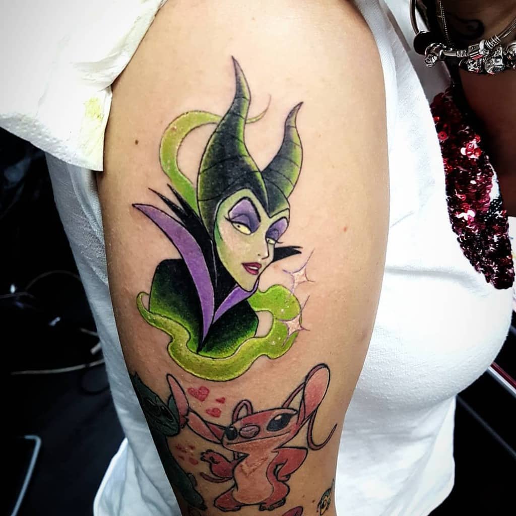 Colorful arm tattoo of Maleficent with vibrant green and purple tones, capturing her iconic villainous charm and magical aura