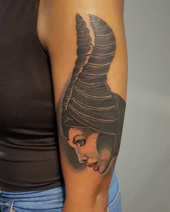 Stylized arm tattoo of Maleficent in profile, featuring bold black horns and a soft expression, highlighting her enigmatic allure