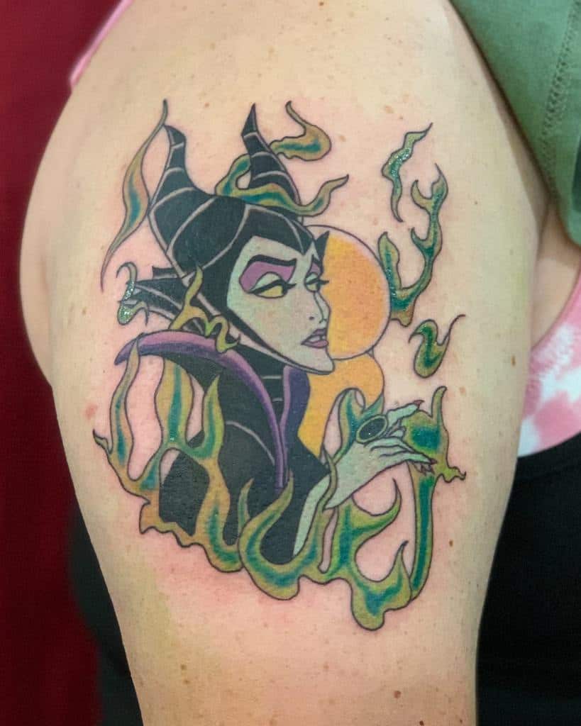 Vibrant Maleficent tattoo featuring green flames and a bold, animated design, capturing her iconic villainous essence on the arm