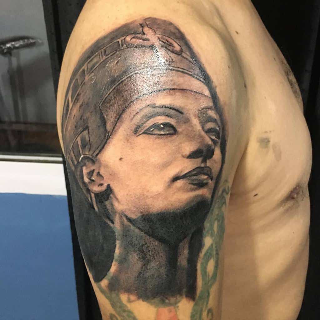 Tattoo of Queen Nefertiti’s bust on an upper arm