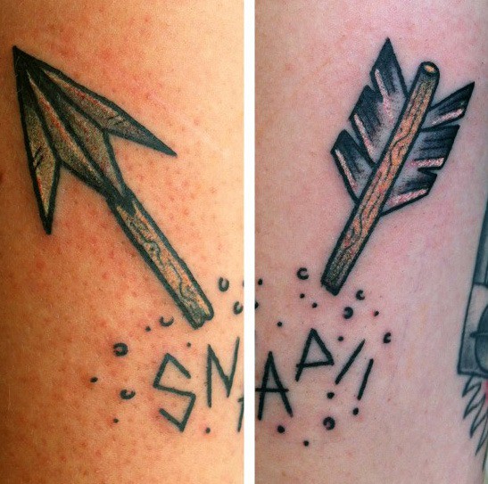 Broken arrow tattoo split into two parts with bold black outlines, surrounded by dots and the word SNAP written in jagged font.