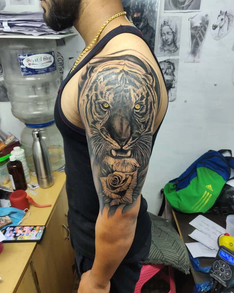 Man with a full sleeve tiger and rose tattoo