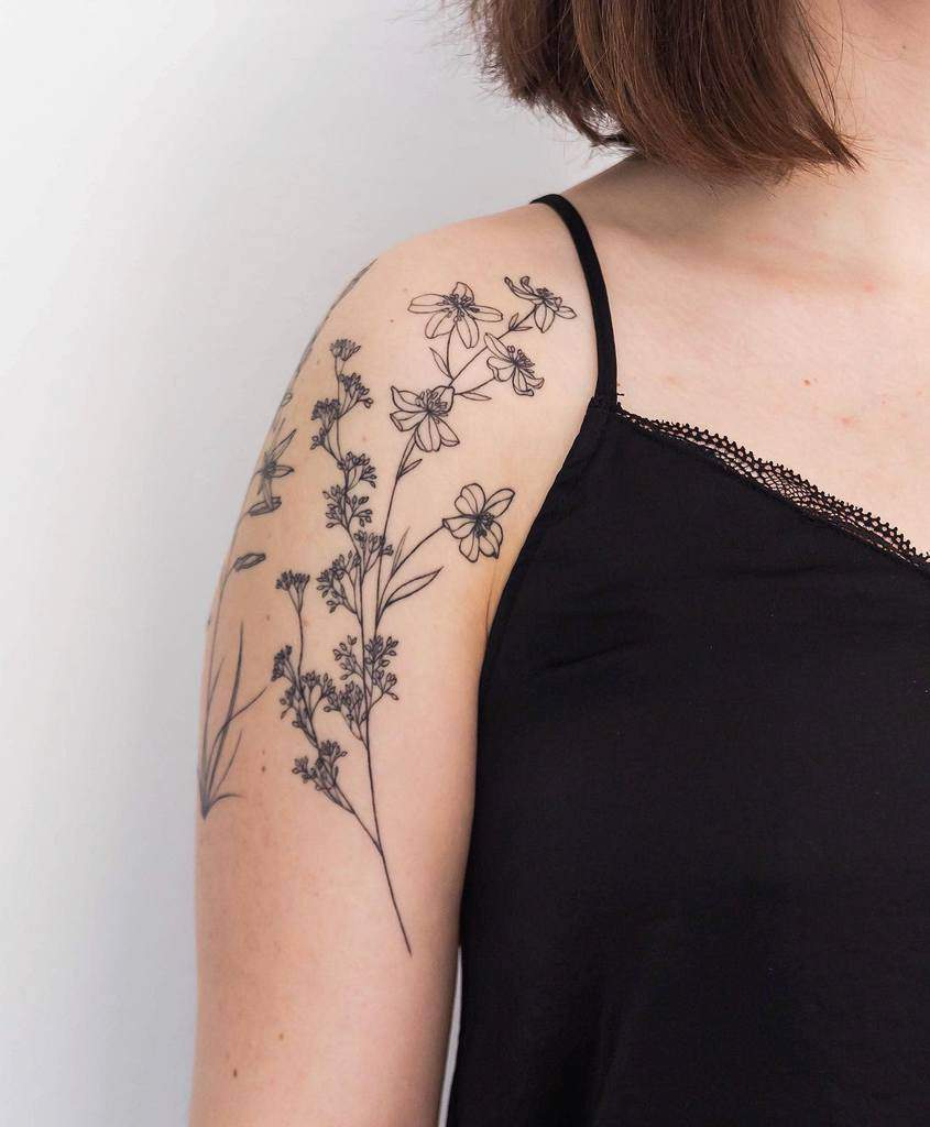 Woman with floral tattoo on her shoulder