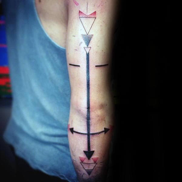 Geometric tattoo with arrows and triangles on a person's arm