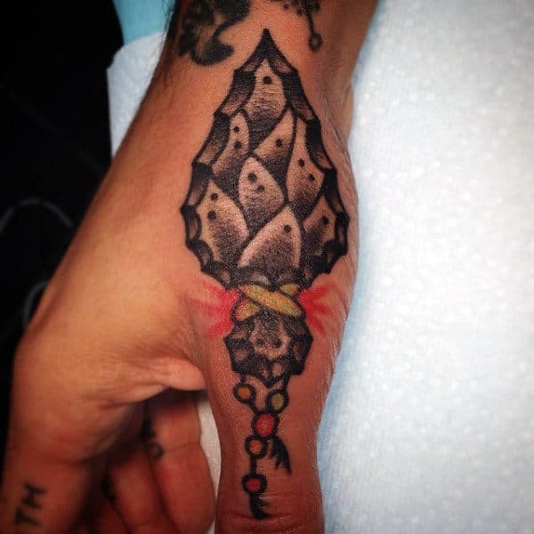 Arrowhead Thumb Tattoo On Man