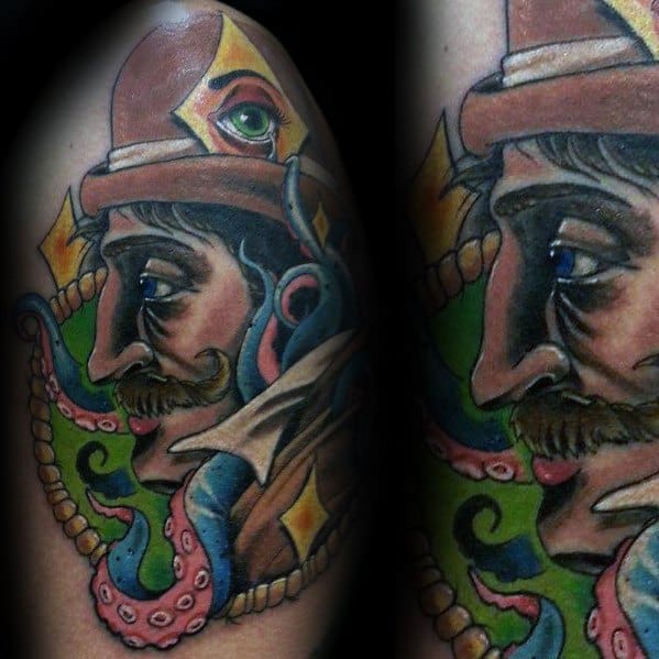 Tattoo of a man with a hat, featuring an eye and octopus tentacles in a colorful, Holmesian abstract style