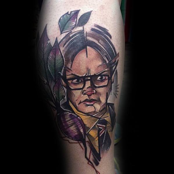 Colorful abstract tattoo of Dwight Schrute with sharp geometric lines, bold shading, and leaves incorporated into the design on a leg.