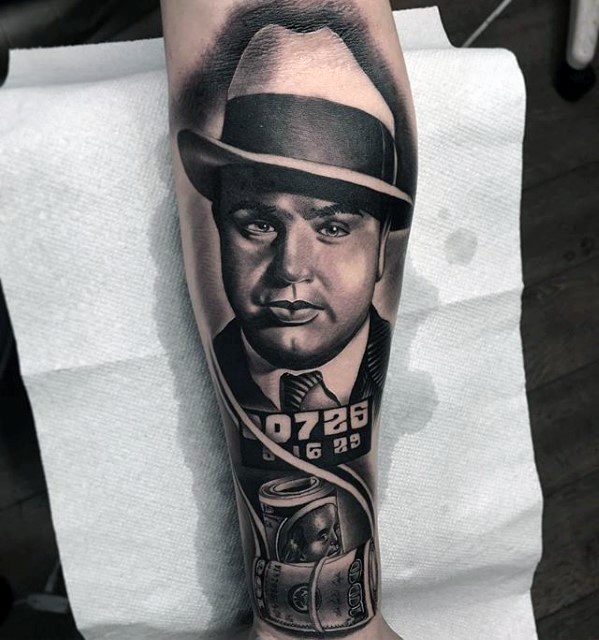 Al Capone tattoo featuring a detailed portrait of the gangster, his inmate number "0726 16 29" and a jar of cash in the design.