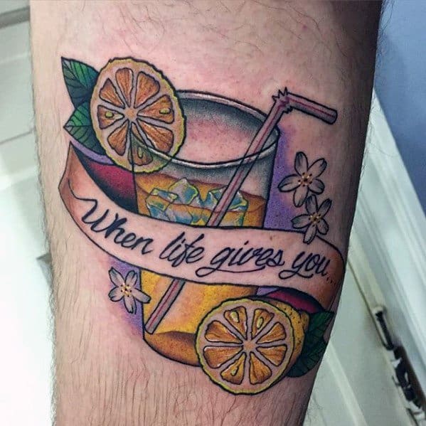Colorful tattoo of a lemonade glass with lemon slices, flowers, and a banner that reads "When life gives you."