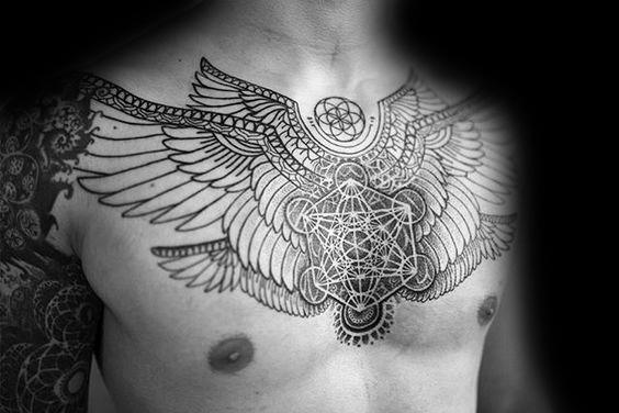 Chest tattoo of Metatron’s Cube with large symmetrical wings and intricate linework, symbolizing protection, power, and sacred geometry.