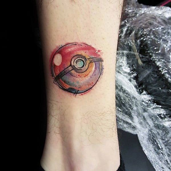 Realistic Pokeball tattoo with a grunge texture and soft red and purple watercolor shading on the lower leg.