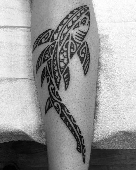 Polynesian shark tattoo on calf with intricate tribal patterns symbolizing guidance, strength, and oceanic protection.