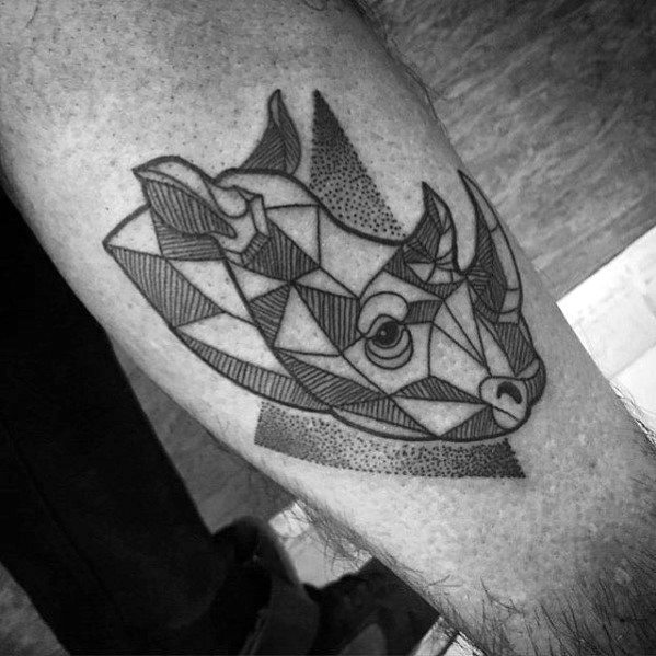 Geometric rhino head tattoo with bold linework and shaded triangles, placed on the calf for a strong and modern tribal feel.