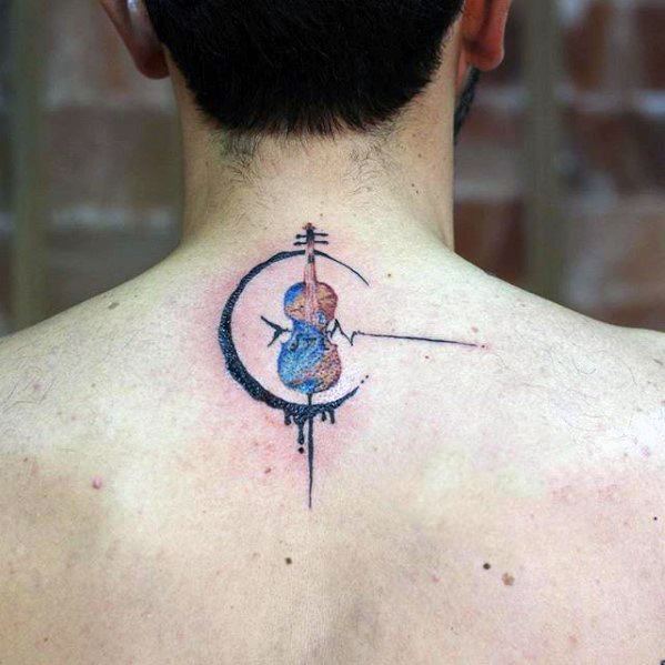 Abstract violin tattoo on the upper back with watercolor-style blue and purple tones, framed by a crescent and dynamic linework.