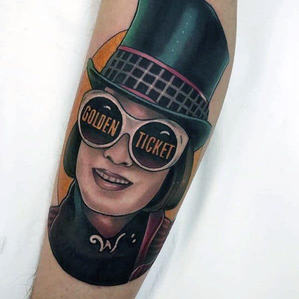 Colorful Willy Wonka tattoo with oversized sunglasses reading Golden Ticket, a tall black hat, and stylized cartoon features.