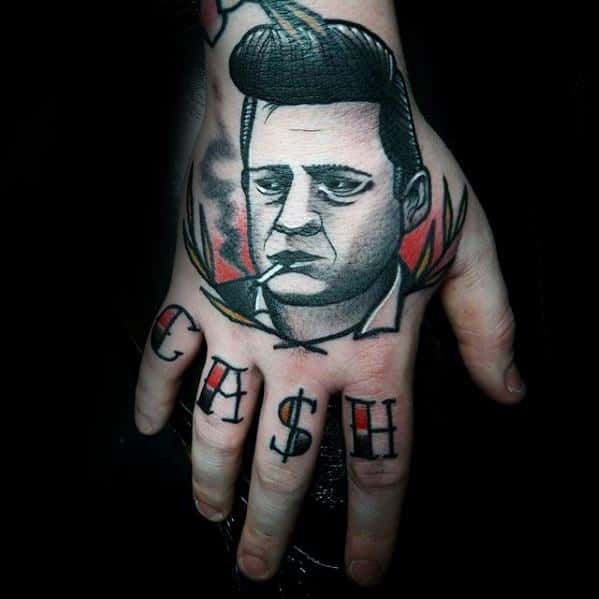Tattoo of Johnny Cash's face on a hand, with "CASH" inked on the fingers