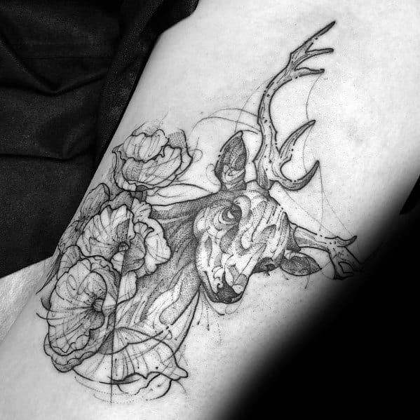 Sketch-style elk tattoo with floral elements on a man's arm, featuring intricate linework and artistic shading for a unique, organic design.