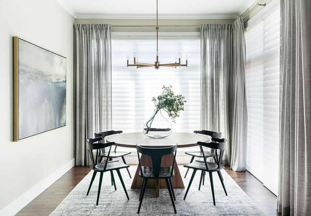 small dining room round table and chairs sputnik chandelier thin gray curtains framed wall art