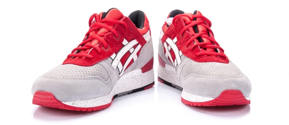 asics red and gray shoes on white surface