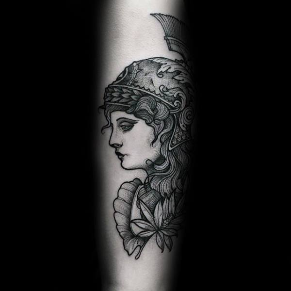 Athena tattoo featuring a side-profile portrait with ornate helmet, detailed hair, and leaf elements in fine black linework