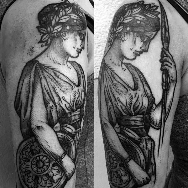 Classical-style Athena tattoo with laurel crown, spear, and shield, featuring graceful drapery and fine blackwork detailing