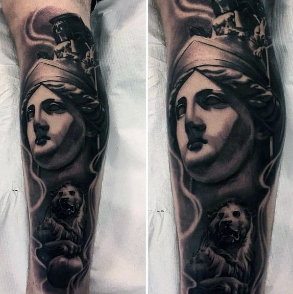 Athena tattoo with a serene face, detailed helmet, and a lion beneath, done in a bold black and grey realism style