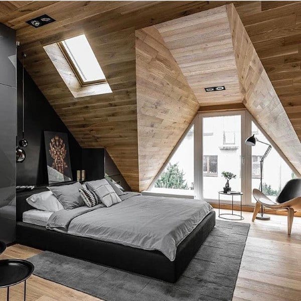 attic style bedroom with wood panel walls