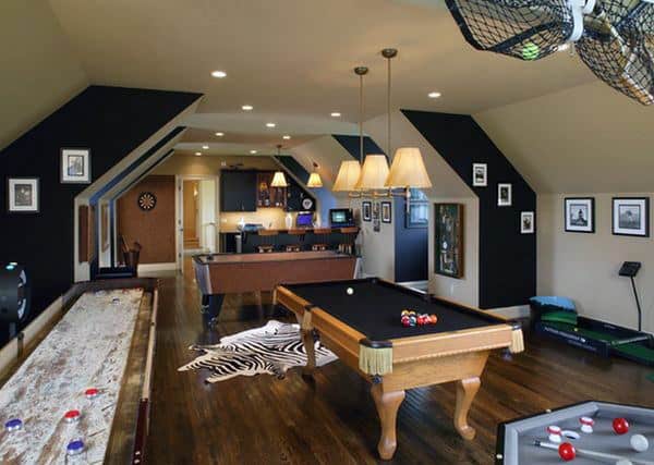 Game room with pool table, shuffleboard, dartboard, bar area, and framed pictures on angled walls