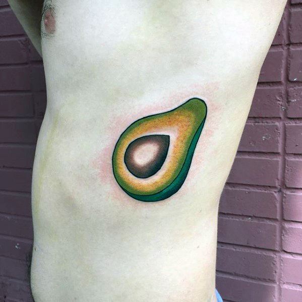 Simple and vibrant avocado tattoo on the ribcage, featuring smooth color gradients and a soft, minimalist style.