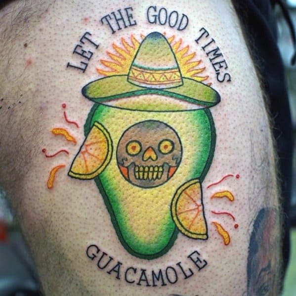 Festive avocado tattoo with a sombrero, skull pit, lime slices, and the phrase “Let the good times guacamole” in vibrant colors.