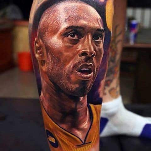 A vibrant tattoo of Kobe Bryant’s face, capturing his intense expression while wearing his Lakers jersey, detailed with rich colors.