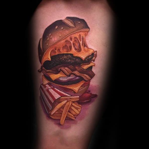 Cheeseburger tattoo with fries, featuring cheese, bacon, onions, and a striped fry container