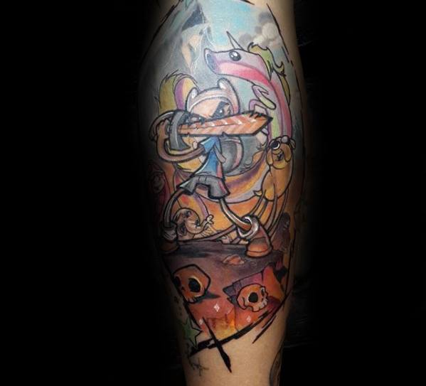 Adventure Time tattoo of Fionna wielding a sword with Cake, Lady Rainicorn, and Jake in a dynamic battle scene, inked on the leg.