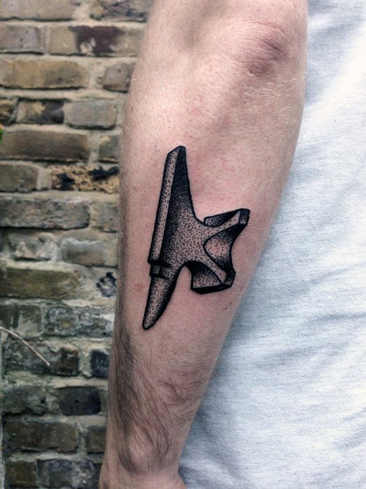 Minimalist anvil tattoo on the forearm with dotwork shading and clean black outline, giving it a sleek and modern look.