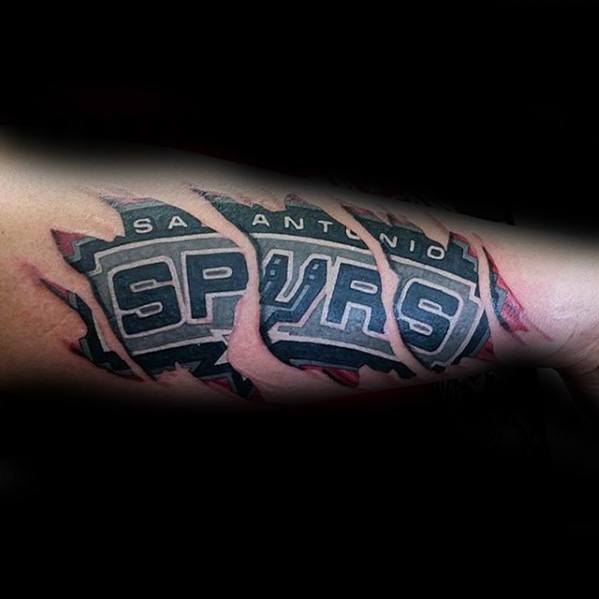 Realistic torn-skin tattoo revealing the San Antonio Spurs logo underneath, with detailed shading and red ink for a ripped effect.