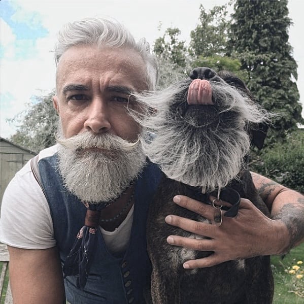 Man With Grey Beard Posting with a Dog