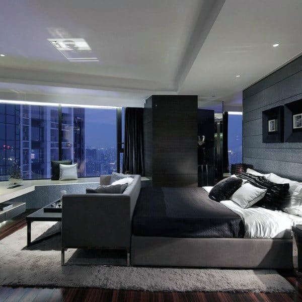 Modern bedroom with city view, sleek black decor, and floor-to-ceiling glass windows.