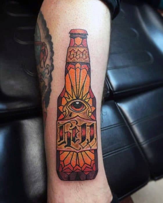 Bold neo-traditional tattoo of a stylized beer bottle featuring geometric stained-glass patterns, an all-seeing eye, and ornamental lettering.