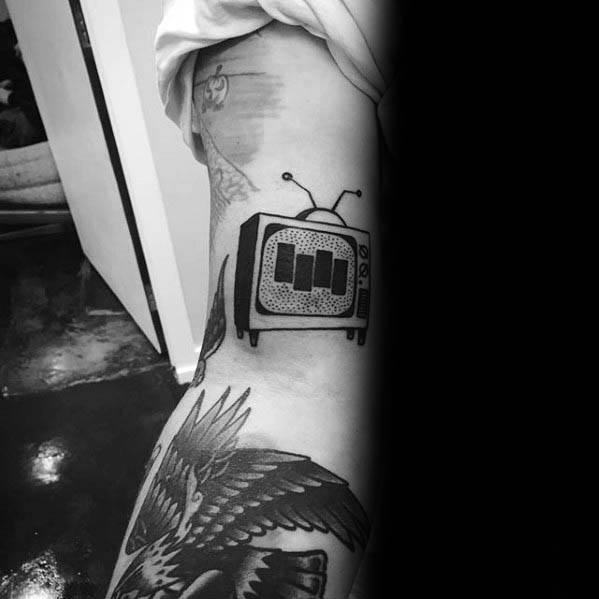 Black Flag bars tattooed inside a retro television design, blending punk rebellion with vintage media symbolism.