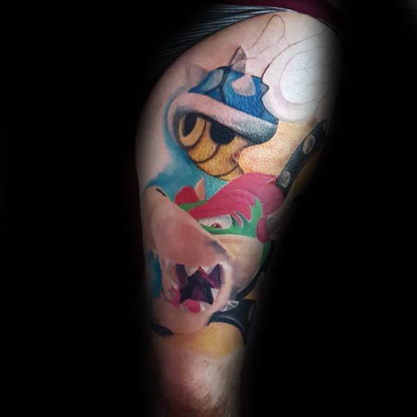 Dynamic Bowser tattoo on a man's leg featuring a bold design with a blue shell in motion, vibrant colors, and smooth shading.