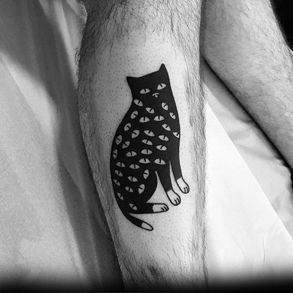 Minimalist black cat tattoo on the leg, featuring multiple eyes within its body for a surreal and mysterious design.