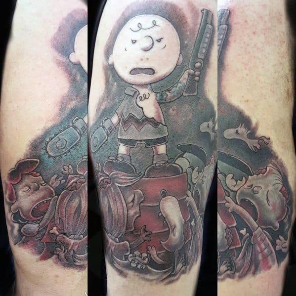 Dark-themed Charlie Brown tattoo featuring him wielding a chainsaw and shotgun in a horror-inspired scene with zombie-like characters.