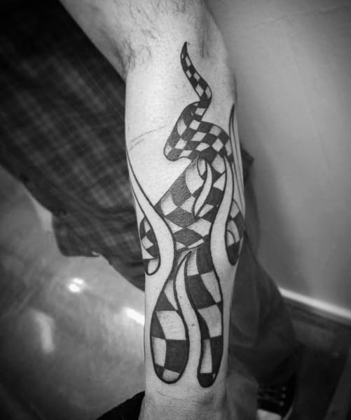 Flowing checkered flag tattoo on the forearm, designed with bold black and white patterns, symbolizing speed and victory.