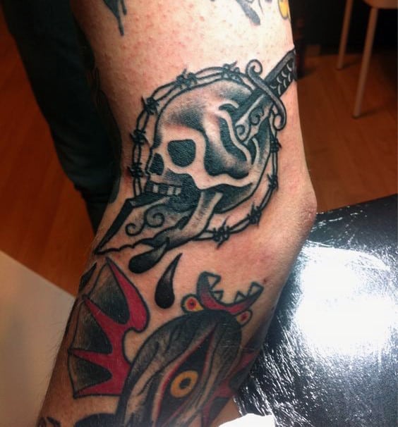 Awesome Dagger Through Skull Mens Barb Wire Tattoo On Arm